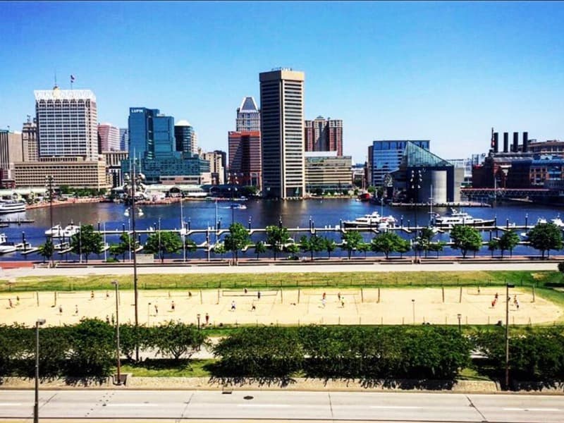 Baltimore Inner Harbor skyline above the beach volleyball courts