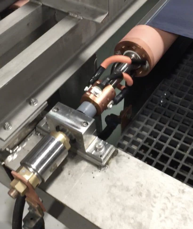Slip ring assembly with copper contacts and water-cooled cabling on a shop floor machine